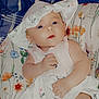 Paisley joined the competition — help win amazing prizes! baby, infant, child, hat, dress, floral_pattern, cushion, blanket, clothing, person, cute, indoors, portrait, skin, hand, face, eyes, babywear, comfort, resting