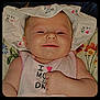 Paisley is registered to the contest to win money with this photo: baby, smiling, hat, clothing, infant, face, portrait, cute, child, sleeveless, blanket, floral, happy, young, skin, person, lying_down, apparel, headwear, indoors