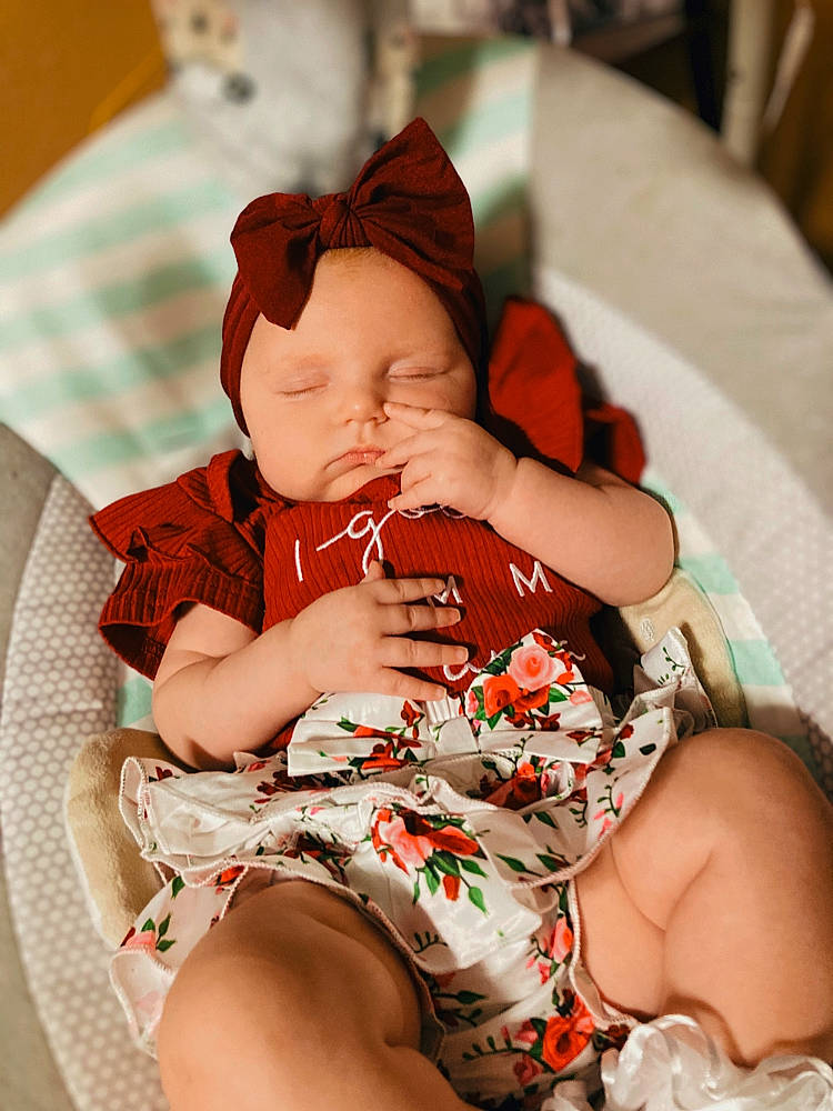 Sadie Mae is registered to the contest to win money with this photo: abdomen, arm, baby, baby_toddler_clothing, chair, chest, child, comfort, finger, hand, headwear, human_leg, knee, lap, nail, pattern, person, sitting, skin, thigh