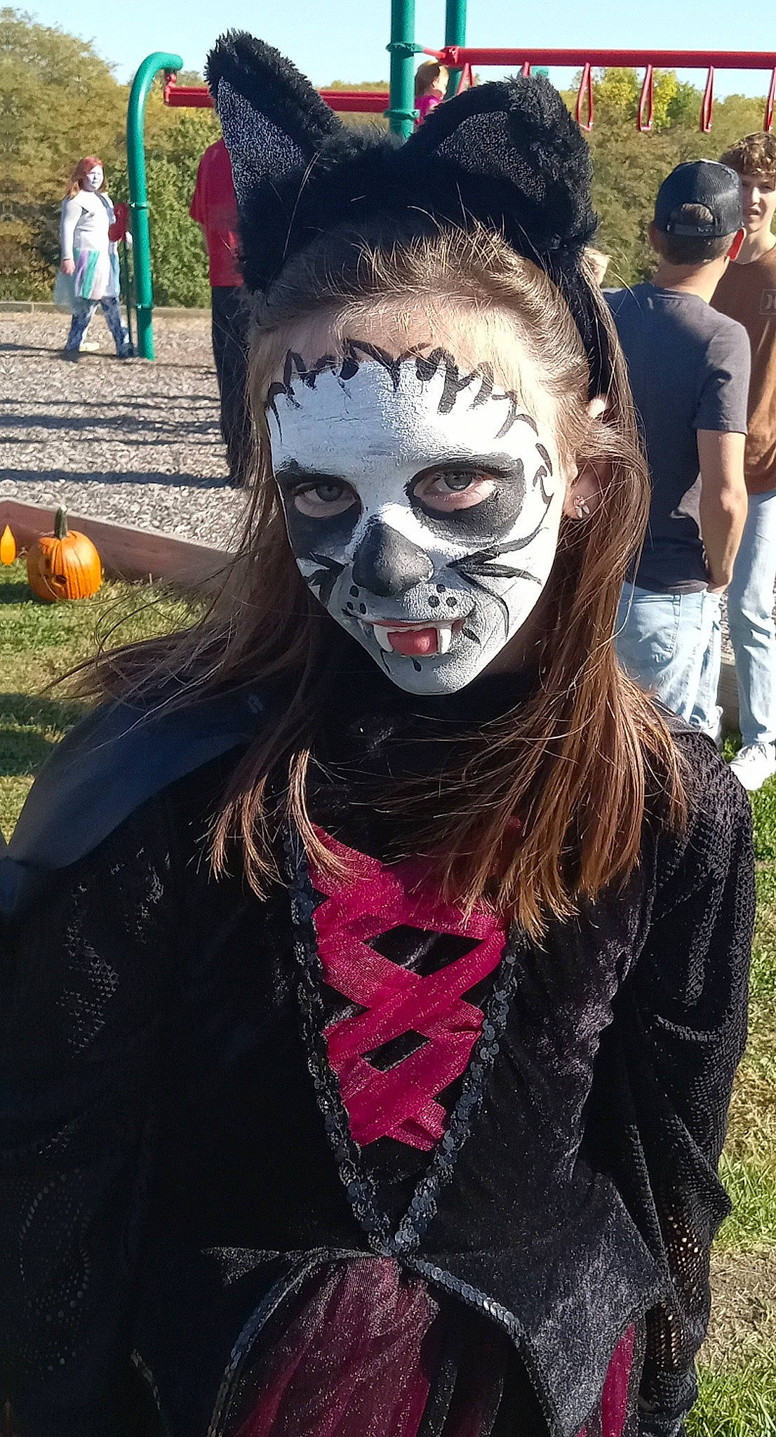 Carolyn is registered to the contest to win money with this photo: clothing, cool, costume, entertainment, event, eyewear, festival, fictional_character, flesh, fun, fur, gourd, grass, green, happy, headgear, mask, masque, performing_arts, person