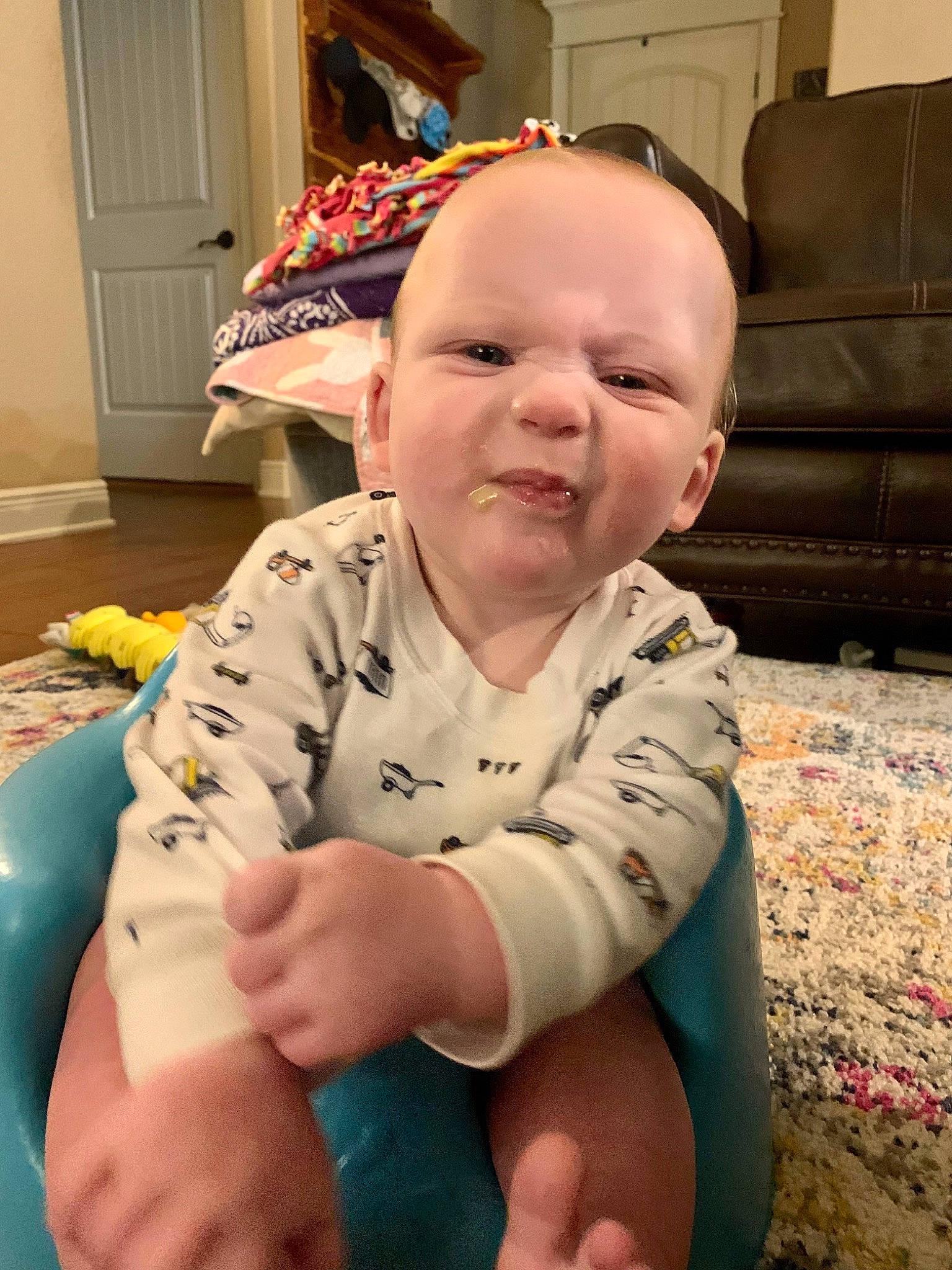 Easton joined the competition — help win amazing prizes! baby, baby_toddler_clothing, blue, cheek, child, chin, comfort, couch, door, finger, flooring, fun, head, mouth, person, sitting, skin, smile, thumb, toddler