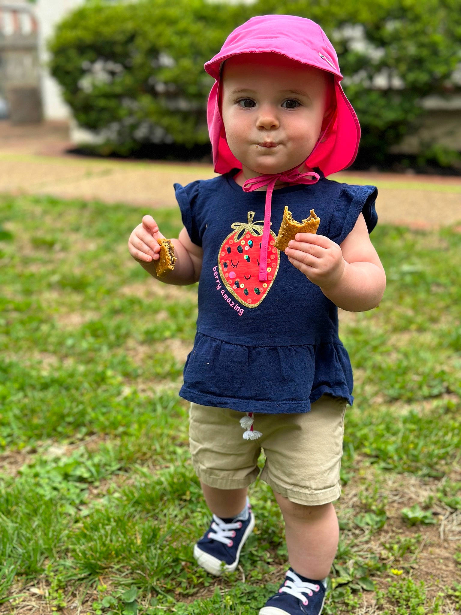 Alexandra is registered to the contest to win money with this photo: baby, baby_toddler_clothing, child, fruit, fun, gesture, grass, happy, headwear, lawn, leisure, people_in_nature, person, pink, plant, shorts, sleeve, sneakers, summer, t_shirt