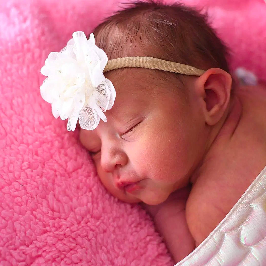 Sawyer is registered to the contest to win money with this photo: baby, baby_sleeping, baby_toddler_clothing, cheek, chin, comfort, ear, eyelash, finger, flower, headgear, headpiece, headwear, lip, nose, person, petal, pink, plant, skin