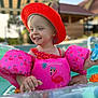 child, toddler, pool, floaties, red_hat, pink, flamingo, summer, water_toy, toy_dolphin, smiling, outdoor, sunny, swimming, swimwear, play, happy, baby, necklace, canopy