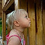 toddler, child, blond_hair, pink_clothing, necklace, outdoor, playground, wood, curious, profile, side_view, young_child, summer, daylight, person, nature, innocence, casual, portrait, young