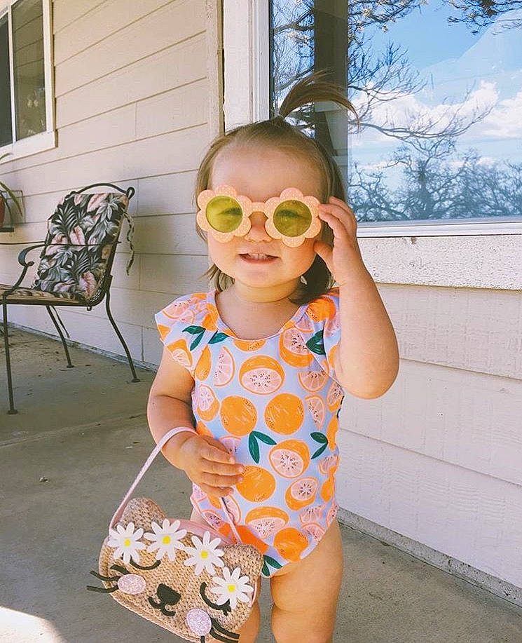 Rowyn is registered to the contest to win money with this photo: child, eyewear, glasses, joy, person, personal_protective_equipment, plant, smile, summer, sunglasses, swimwear, toddler, vacation, vision_care, yellow