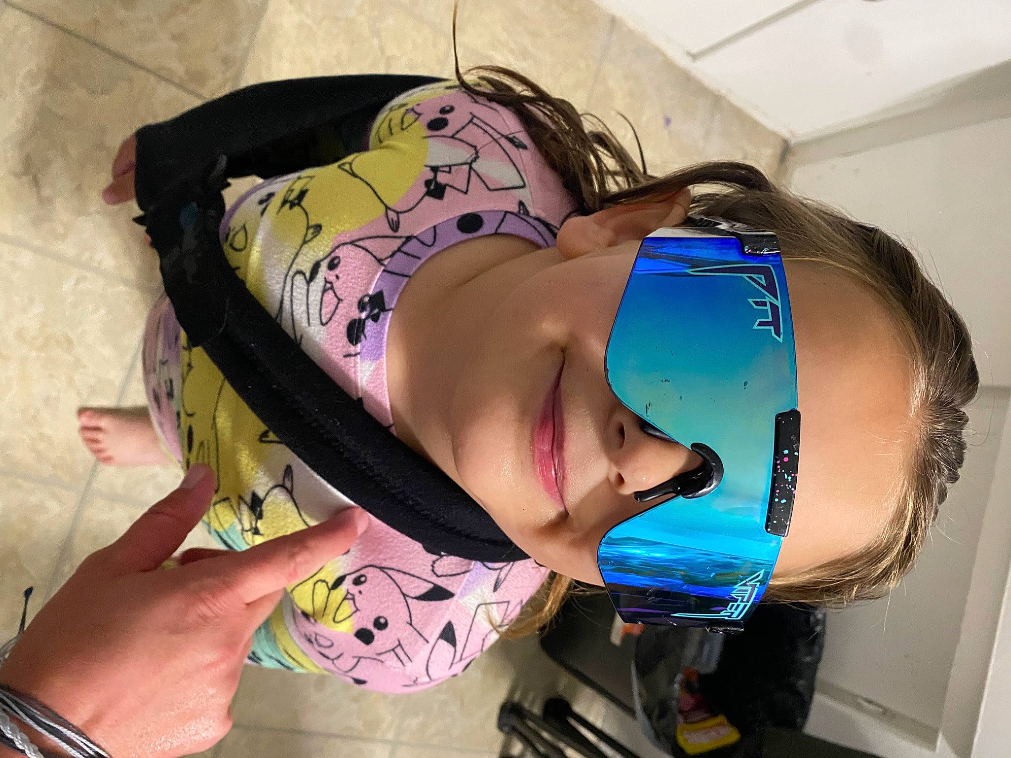 Charlie is registered to the contest to win money with this photo: abdomen, black_hair, chest, dress, elbow, electric_blue, eyelash, eyewear, fashion_accessory, hairstyle, hat, headgear, helmet, human_leg, joy, long_hair, mouth, person, personal_protective_equipment, thigh