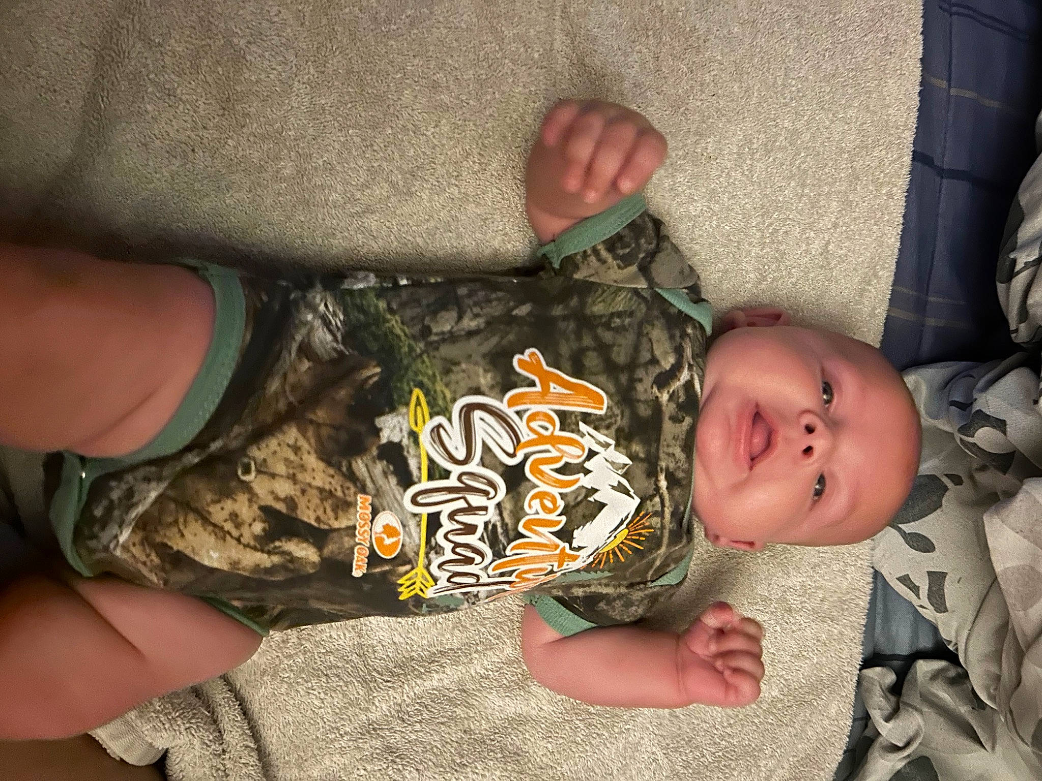 Easton Atlas Ray Moore joined the competition — help win amazing prizes! baby, baby_toddler_clothing, camouflage, cheek, child, comfort, elbow, finger, gesture, human_leg, military_camouflage, nail, pattern, person, sitting, sleeve, thigh, thumb, toddler, wood