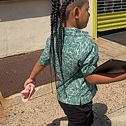 Jeremy joined the competition — help win amazing prizes! child, braided_hair, green_shirt, black_pants, tablet, sidewalk, sunlight, urban, yellow_door, metal_shutter, footwear, walking, outdoor, shadow, person, casual_clothing, handheld_item, concrete, street, daylight