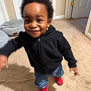 Justen is registered to the contest to win money with this photo: toddler, child, smiling, indoor, carpet, black_hoodie, jeans, red_shoes, happy, motion, person, cute, home, young_child, standing, expression, face, hair, casual_clothing, door