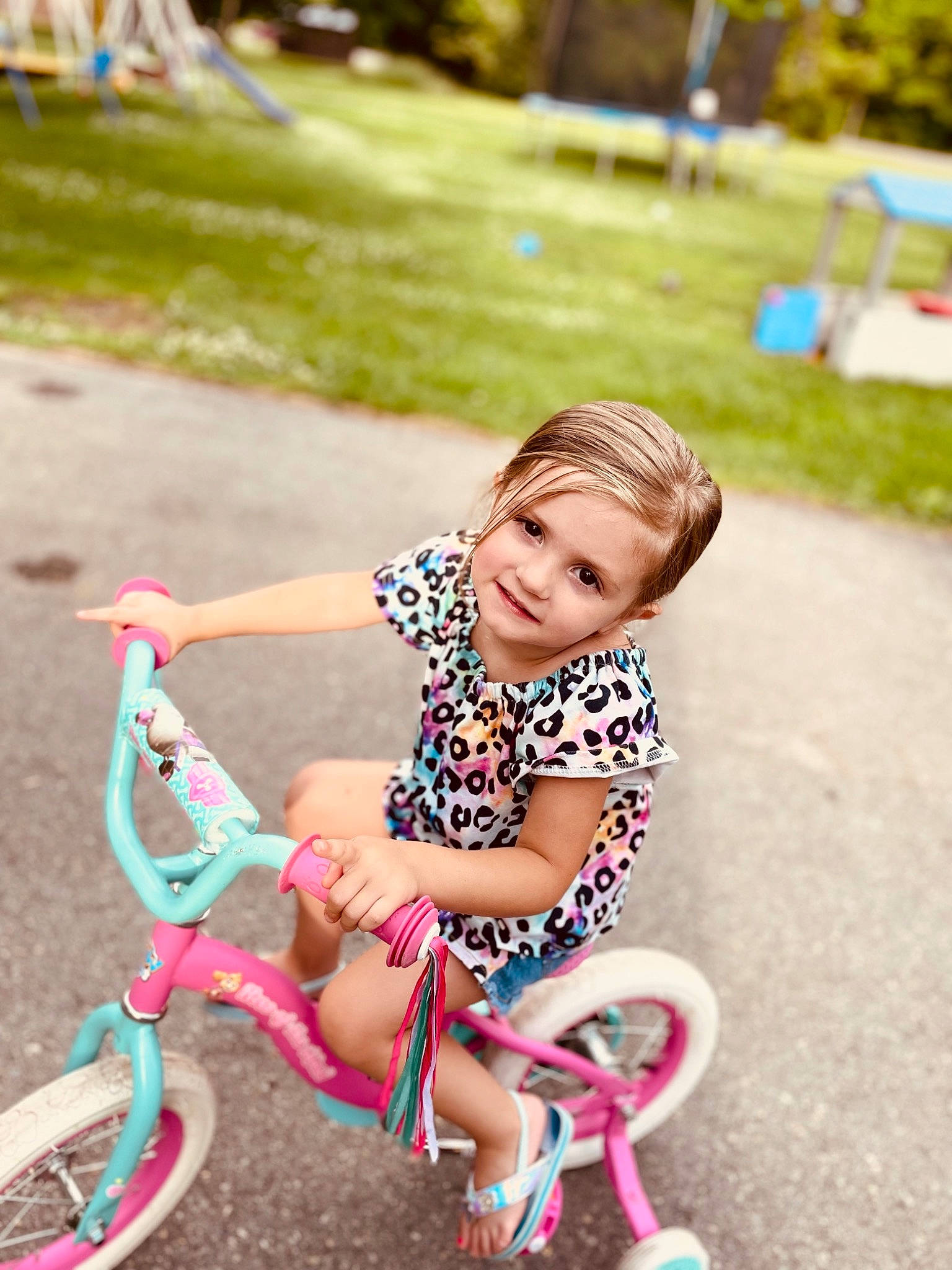Jacquelyn joined the competition — help win amazing prizes! automotive_tire, baby_toddler_clothing, bicycle, bicycle_accessory, bicycle_handlebar, bicycle_tire, dress, fun, grass, happy, joy, leg, leisure, person, pink, plant, riding_toy, shorts, smile, tire