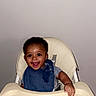 Kiyear is registered to the contest to win money with this photo: baby, high_chair, bib, smile, happy, indoor, child, feeding, bowl, spoon, person, toddler, cute, young_child, infant, tableware, seat, joyful, face, meal