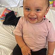 Andres joined the competition — help win amazing prizes! toddler, child, smiling, sitting, indoors, bed, clothing, shorts, tshirt, sock, toy, background, happy, face, person, cute, young_child, home, casual, skin