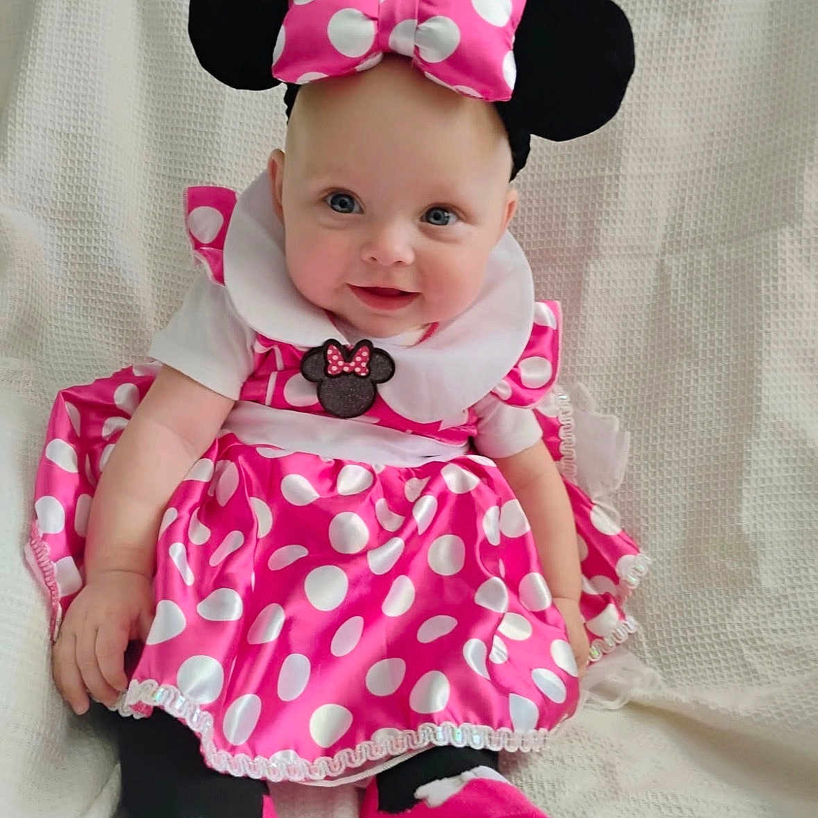 Historia is registered to the contest to win money with this photo: baby, bow, child, costume, cute, dress, footwear, happy, headband, indoors, infant, person, pink, playful, polka_dot, portrait, sitting, smiling, sock, white_background