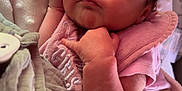 Soraya is registered to the contest to win money with this photo: baby, blanket, closed_eyes, comfort, cozy, cute, face, hand, indoors, infant, newborn, peaceful, pink_clothing, portrait, resting, sleeping, soft_texture, toddler, warm, young_child