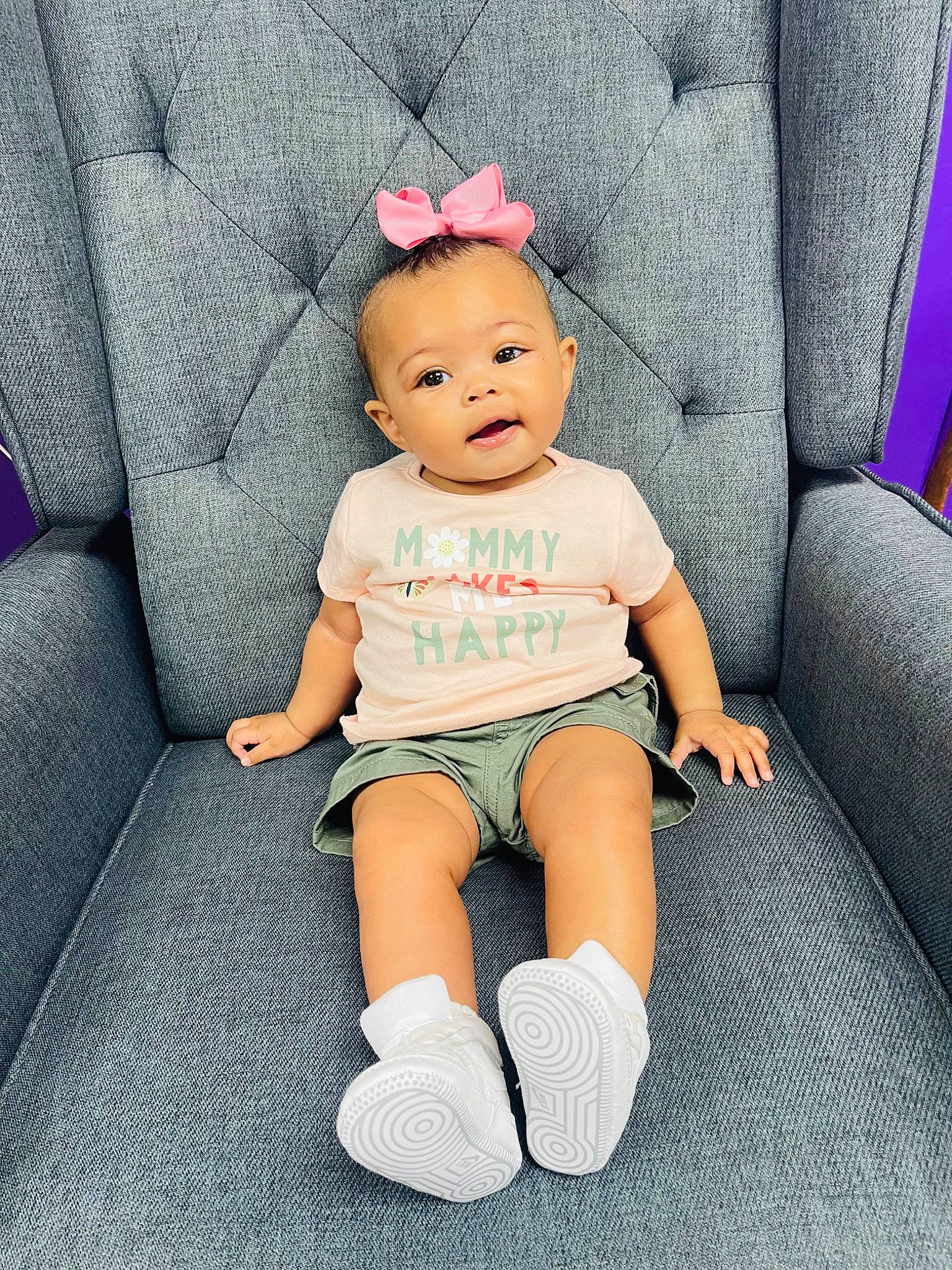 Tylaiah is registered to the contest to win money with this photo: arm, baby, baby_toddler_clothing, child, comfort, couch, electric_blue, eye, foot, hairstyle, human_leg, knee, pattern, person, sitting, skin, sleeve, sock, thigh, toddler