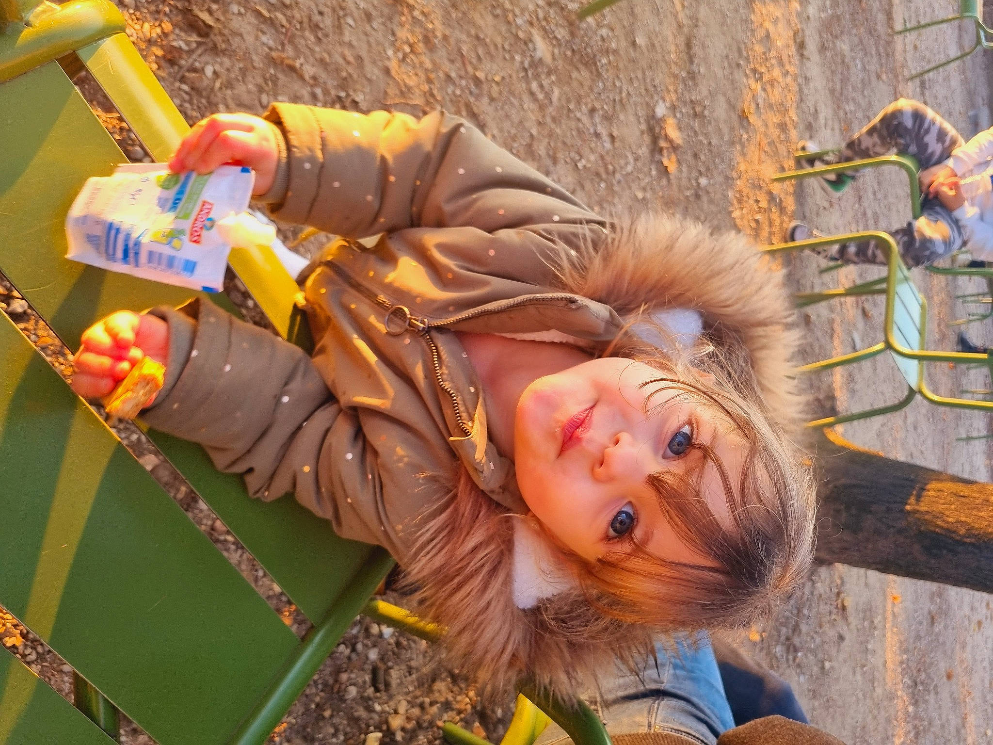 Noëlyne a rejoint le concours — aidez-le/la à gagner de superbes lots ! child, fun, fur, grass, happy, jacket, leisure, orange, people_in_nature, person, plant, recreation, sitting, travel, tree, vacation, wood, yellow