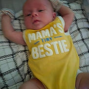 Mason joined the competition — help win amazing prizes! baby, infant, yellow_onesie, text_on_clothing, blanket, patterned_blanket, lying_down, arms_outstretched, cute, child, young_baby, clothing, soft_fabric, indoors, resting, newborn, human, person, casual, relaxed
