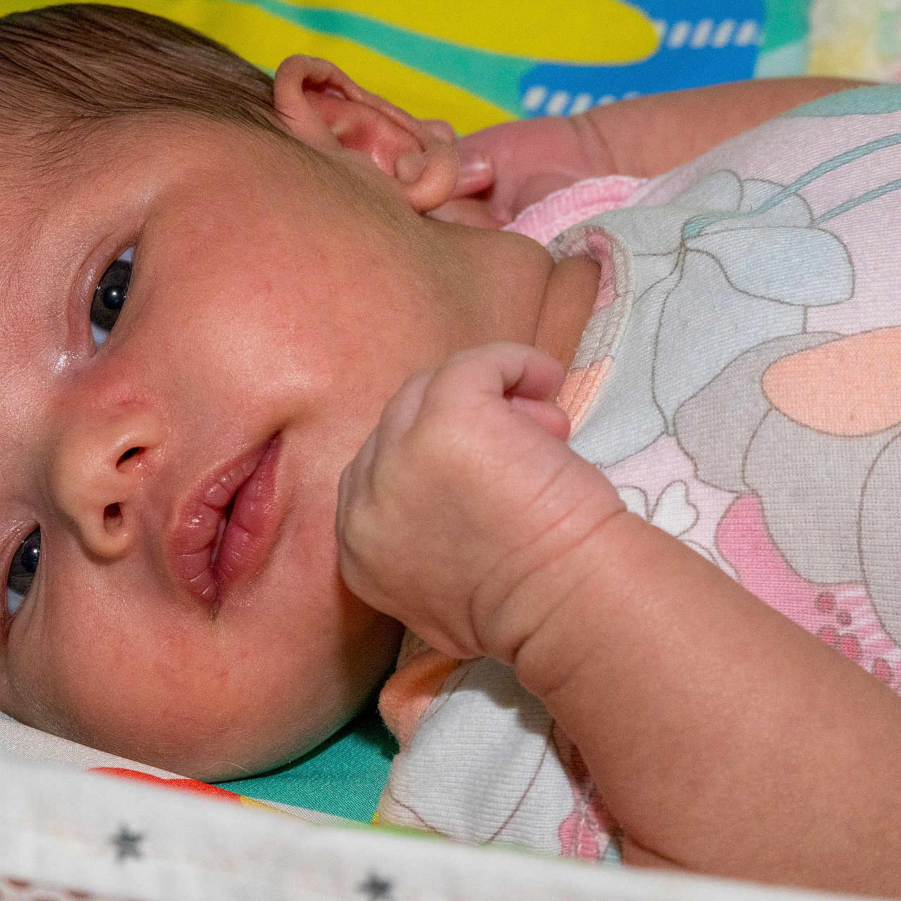 Akira is registered to the contest to win money with this photo: newborn, baby, infant, closeup, face, skin, hand, onesie, floral, pastel_colors, lying_down, bedding, soft, cute, portrait, child, sleepwear, resting, indoors, peaceful