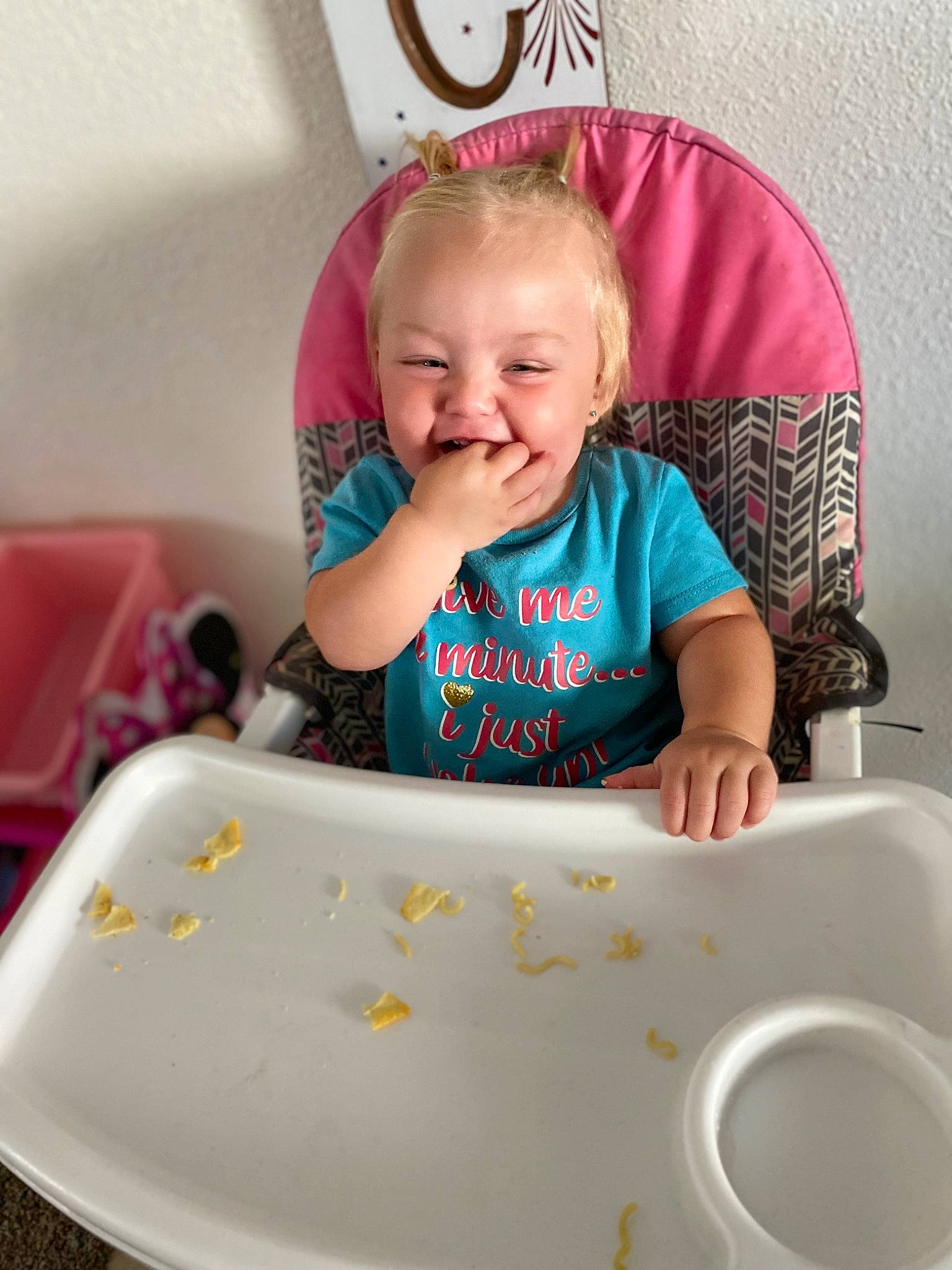 Dixie is registered to the contest to win money with this photo: baby, baby_playing_with_toys, baby_products, baby_toddler_clothing, chair, child, dishware, fashion_accessory, fun, happy, person, pink, product, room, sitting, sleeve, smile, t_shirt, table, toddler