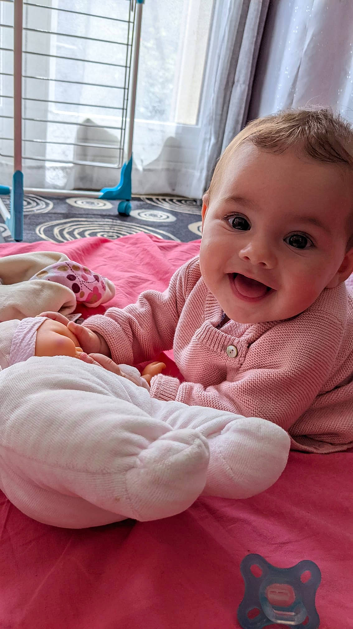 Louisa participe au concours pour gagner de l'argent avec cette photo : baby, baby_toddler_clothing, cheek, child, comfort, curtain, facial_expression, flooring, happy, linens, magenta, mammal, people, person, pink, product, sitting, skin, smile, textile