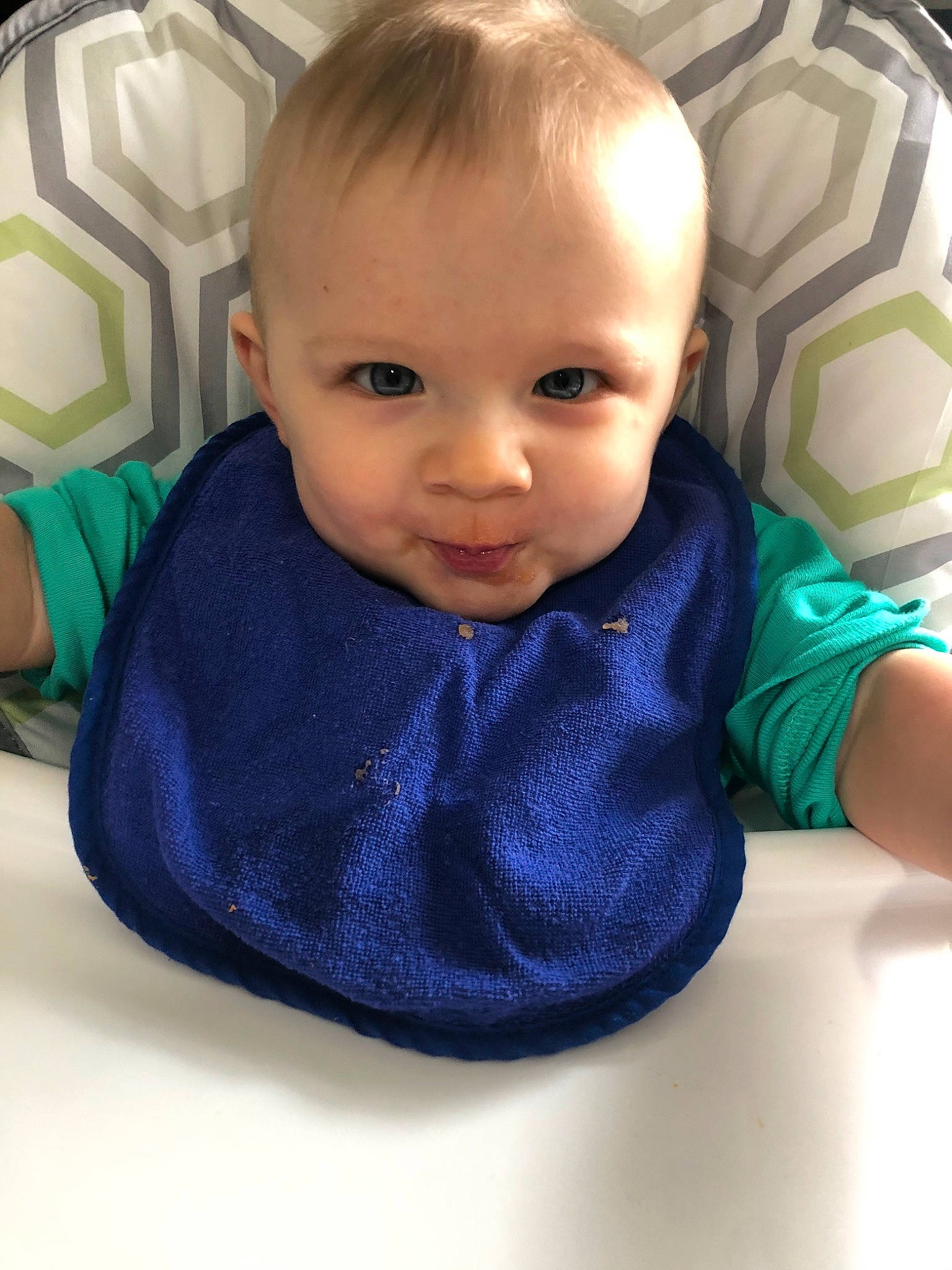 Georgie is registered to the contest to win money with this photo: baby, baby_toddler_clothing, blue, cheek, child, chin, ear, eye, face, forehead, head, lip, mouth, neck, nose, person, product, sitting, skin, sleeve