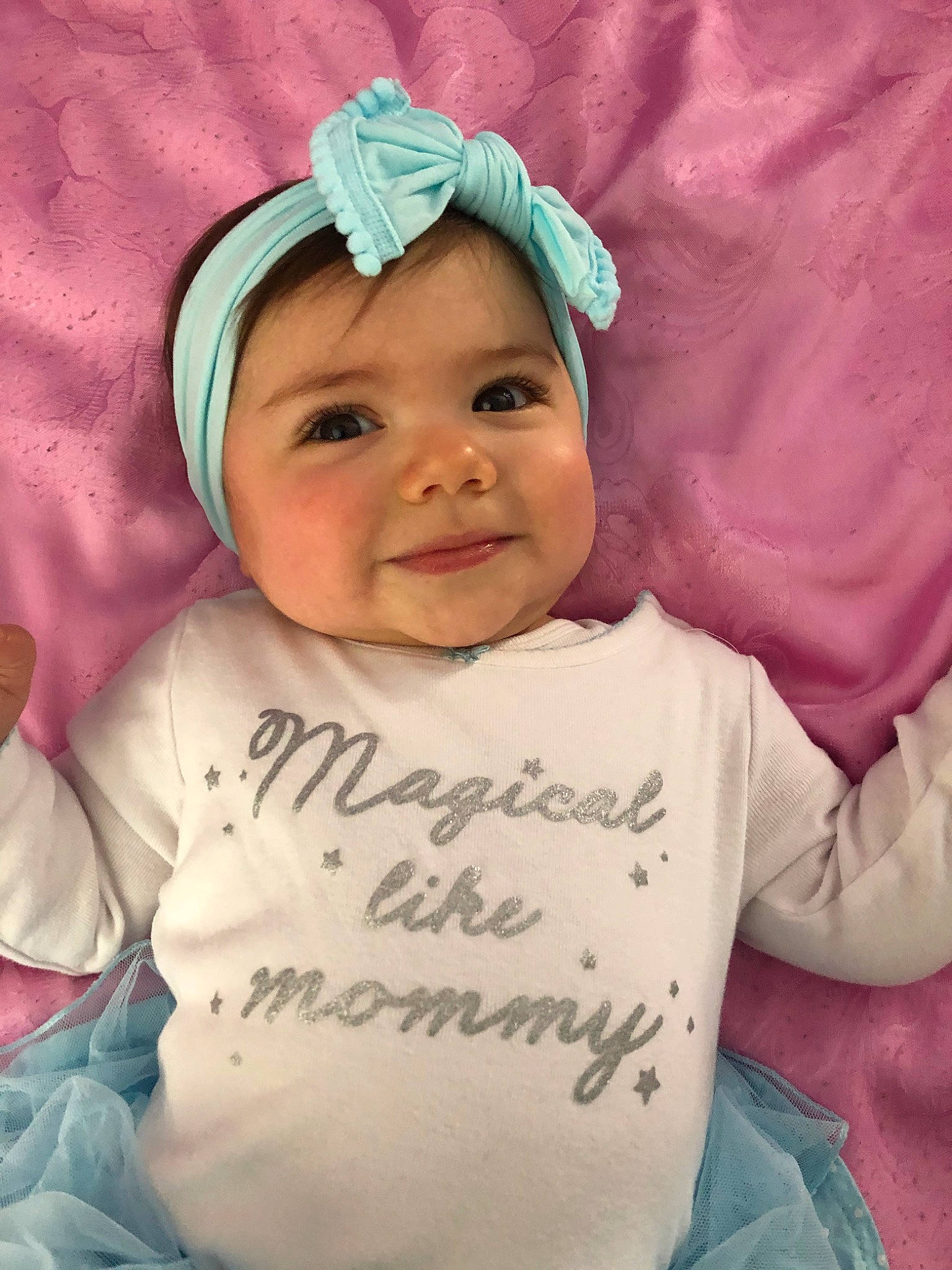 Gina is registered to the contest to win money with this photo: baby, baby_toddler_clothing, cheek, child, forehead, hair_accessory, head, headgear, headwear, joy, person, pink, smile, toddler