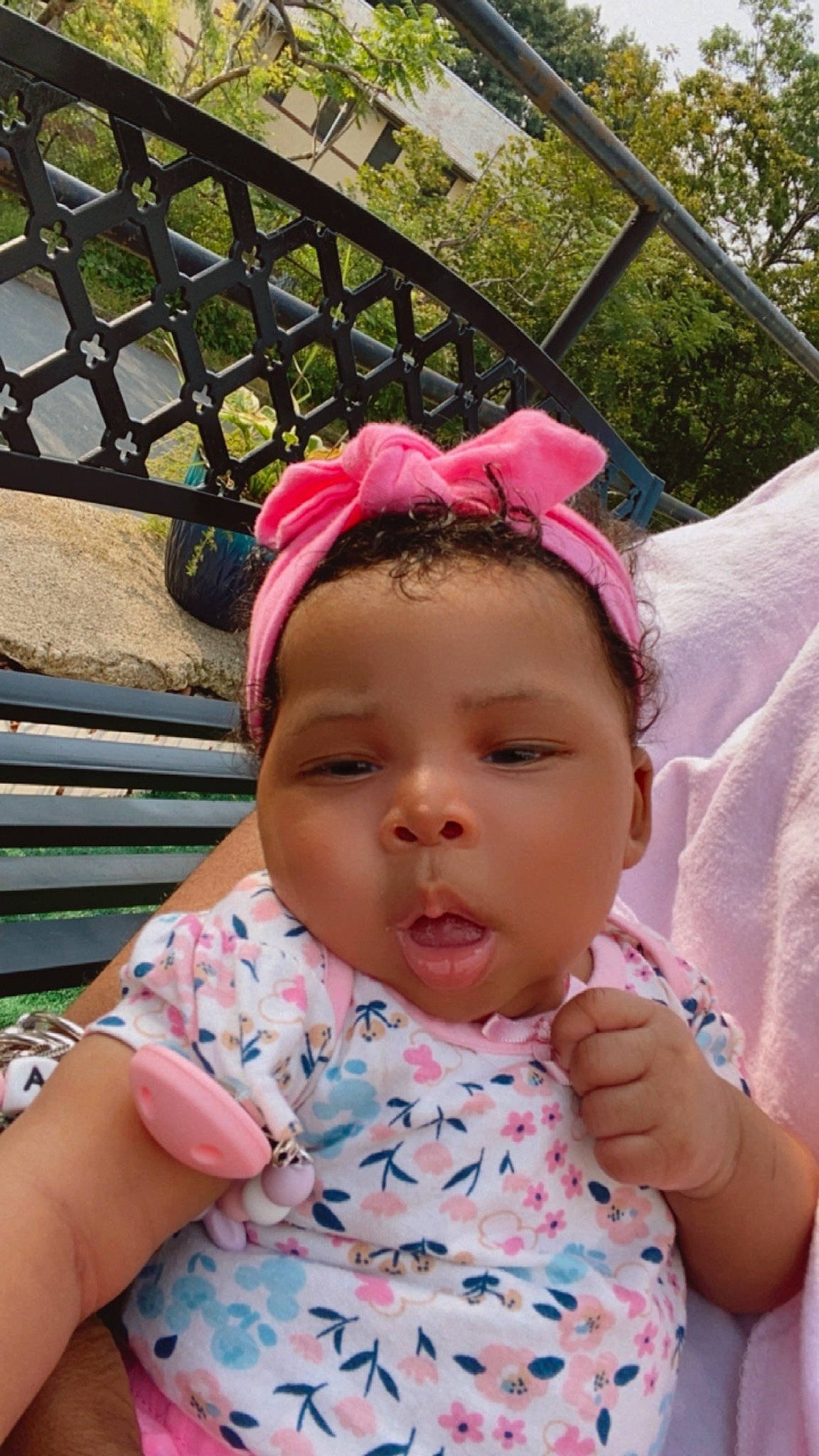 Jahnea is registered to the contest to win money with this photo: baby, baby_toddler_clothing, cheek, chin, eyelash, face, finger, grass, hand, happy, head, headgear, lip, mouth, nose, organ, person, pink, plant, skin