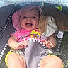 baby, smiling, pink_hat, pink_shirt, stroller, blanket, plush_toy, outdoor, child, happy, legs, feet, sunshade, cute, infant, playful, summer, seat, clothing, person