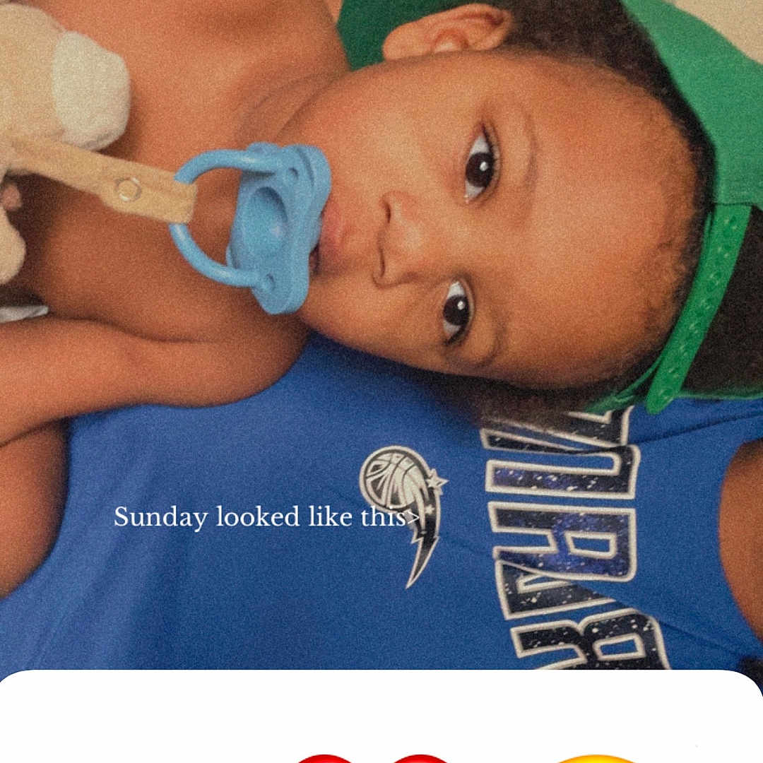 Jessuan is registered to the contest to win money with this photo: baby, blue_shirt, casual, child, clothing, cute, emoji, face, green_cap, hand_gesture, heart_emoji, indoor, infant, lying_down, pacifier, person, relaxed, skin, smiling_face_emoji, text_overlay