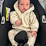 apparel, baby, car_seat, child, clothing, comfort, cute, expression, hands, hoodie, indoors, infant, person, portrait, restraint, safety, seat, seatbelt, socks, young