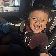 Adam joined the competition — help win amazing prizes! child, toddler, car_seat, car_interior, smiling, happy, seatbelt, short_hair, casual_clothing, sunlight, window, drink_container, blue, seat, person, portrait, daylight, vehicle, joy, candid