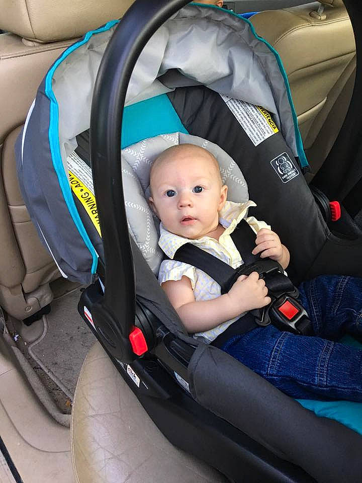 Wyatt is registered to the contest to win money with this photo: automotive_design, baby_carriage, baby_products, car, car_seat, car_seat_cover, child, infant, motor_vehicle, person, product, steering_part, toddler, vehicle