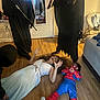 Kristopher joined the competition — help win amazing prizes! child, woman, costume, spiderman, dress, floor, indoor, mirror, reflection, wooden_floor, black_cloak, prop, playful, scared, person, home, casual, light, furniture, footwear