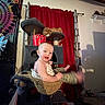 baby, cat, cat_tree, hammock, red_curtain, indoor, child, tapestry, playful, pet, furniture, animal, person, curious, cozy, home, leisure, cute, smile, room