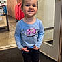 Lanie joined the competition — help win amazing prizes! toddler, child, smiling, indoor, boots, blue_shirt, messy_face, floor_mat, door, glass, storage_cabinets, concrete_floor, playful, standing, long_sleeve_shirt, under_armour, young_child, casual_clothing, happy, portrait