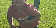 Lanie is registered to the contest to win money with this photo: child, toddler, swing, playground, grass, outdoor, summer, sunlight, greenery, smile, barefoot, shorts, tshirt, happy, nature, sky, clouds, play, fun, daytime
