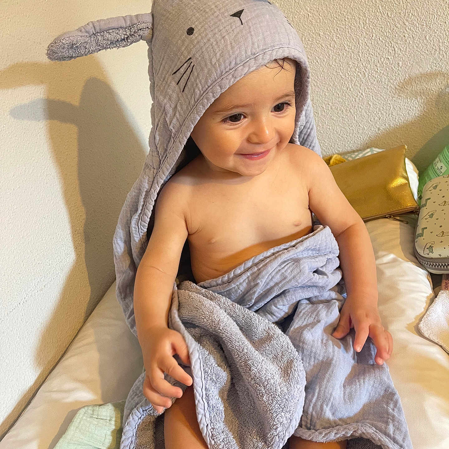 Elias Mikhaël participe au concours pour gagner de l'argent avec cette photo : baby, bed, blanket, bunny_ears, child, cozy, cute, happy, hooded_towel, indoor, light, person, shadow, sitting, skin, smiling, soft_texture, toddler, towel, young_child