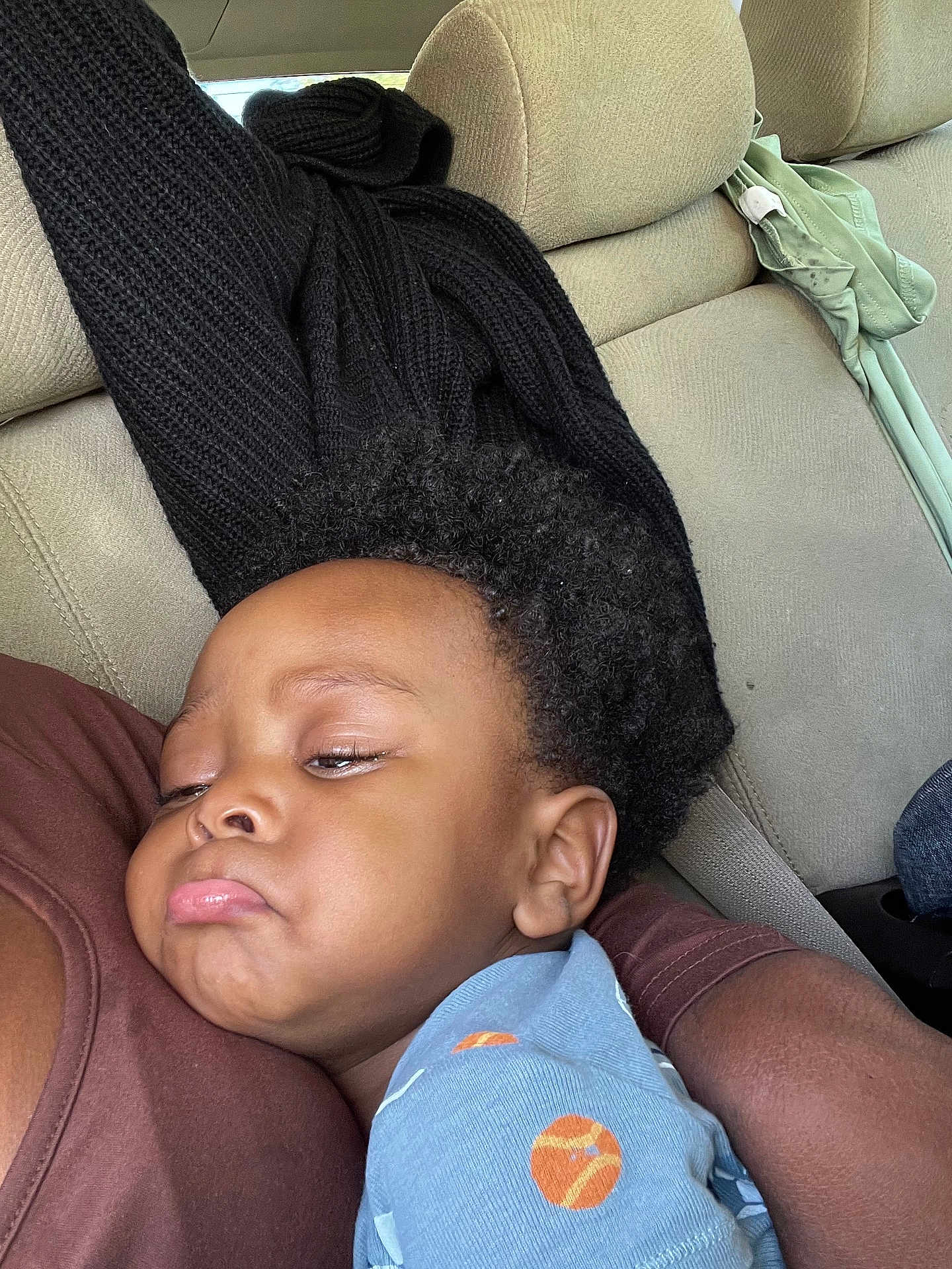 Zamell joined the competition — help win amazing prizes! adult_arm, black_sweater, blue_shirt, car_interior, child, closeup, clothing, comfort, cuddle, curly_hair, patterned_shirt, person, portrait, pout, relax, rest, seat, seatbelt, sleepy, toddler