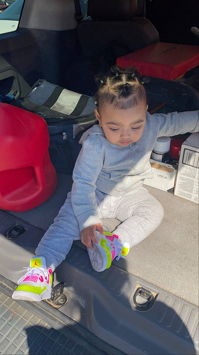 Sariah is registered to the contest to win money with this photo: auto_part, automotive_design, automotive_exterior, car_seat, chair, child, comfort, fun, lap, leisure, luxury_vehicle, motor_vehicle, person, play, recreation, shoe, sitting, snapshot, sneakers, toddler
