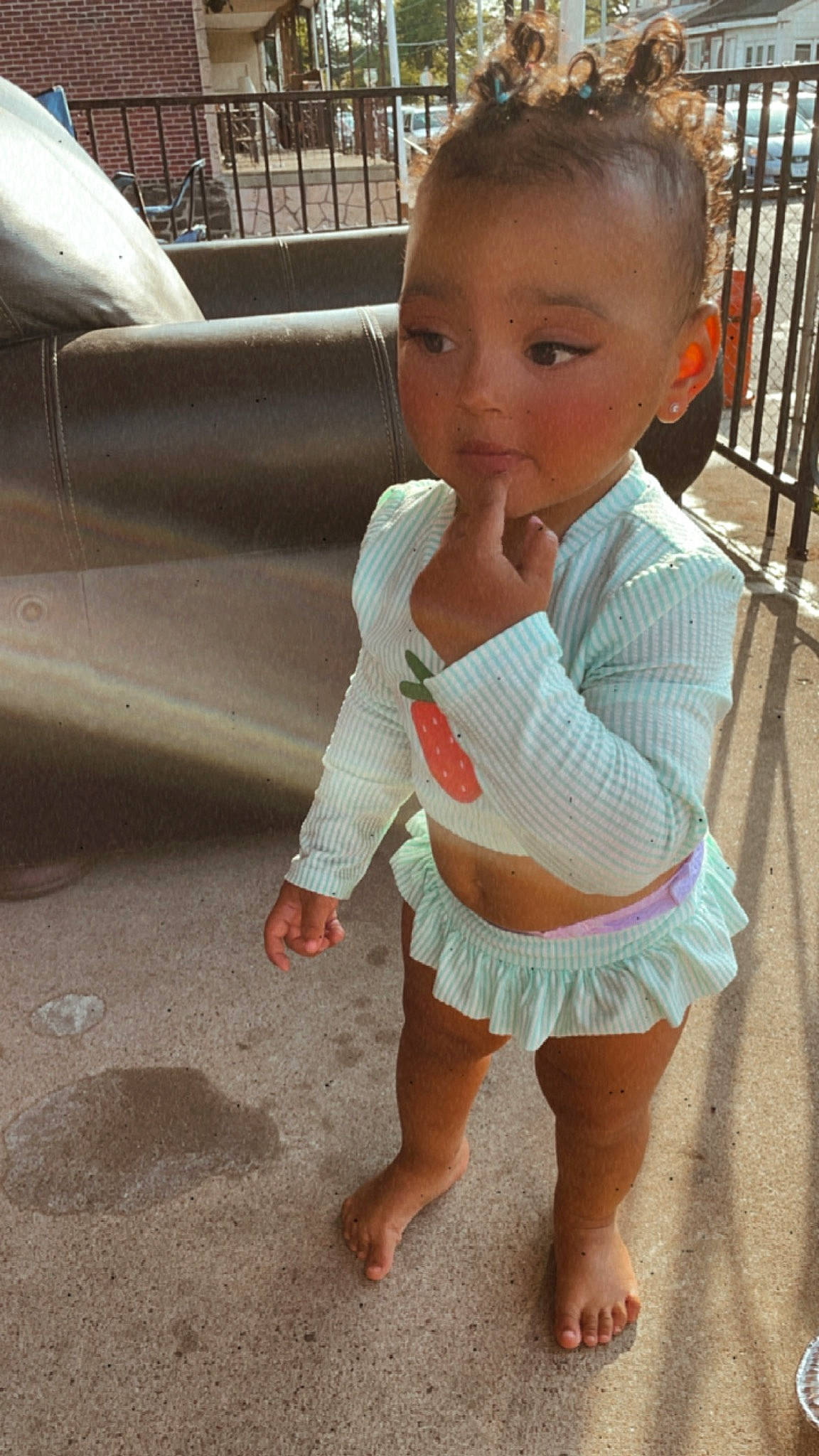 Sariah is registered to the contest to win money with this photo: arm, baby_toddler_clothing, barefoot, face, facial_expression, finger, floor, flooring, hair, hairstyle, hand, happy, head, joint, leg, organ, person, skin, sleeve, standing