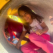 Isabella joined the competition — help win amazing prizes! child, children, playground, tunnel, smiling, happy, play, outdoor, sunlight, girl, casual_clothing, pink_pants, white_shirt, yellow, fun, friends, daylight, play_equipment, joy, candid