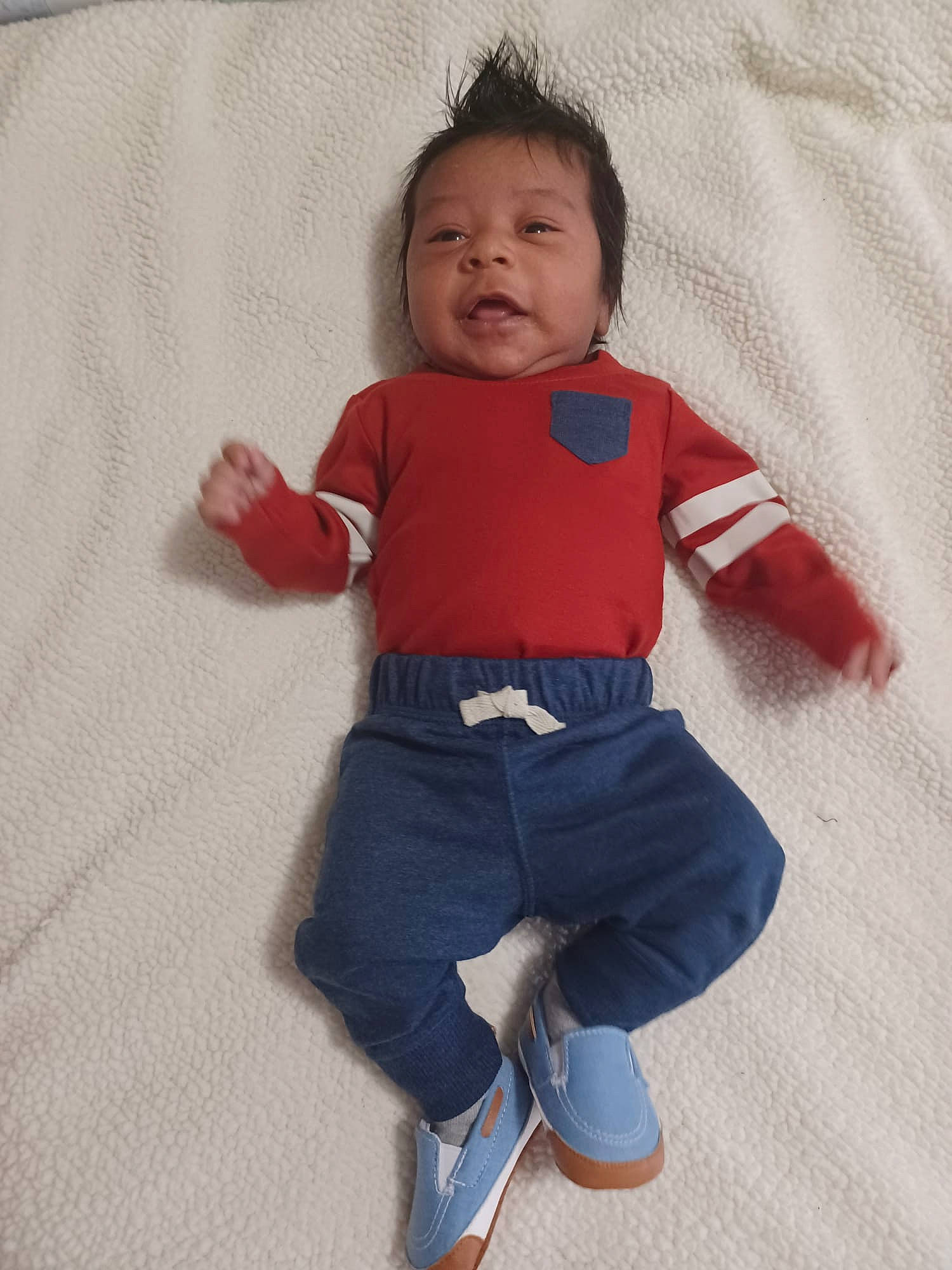 Samuel is registered to the contest to win money with this photo: baby, baby_toddler_clothing, child, collar, comfort, denim, electric_blue, flooring, happy, human_body, linens, long_sleeved_t_shirt, pattern, person, sitting, sleeve, sportswear, t_shirt, textile, toddler