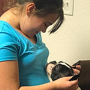 Pixie Lespade joined the competition — help win amazing prizes! woman, dog, indoor, affection, blue_shirt, pet, love, face, ear, holding, closeup, human, canine, collar, light_switch, brown_furniture, caring, friendship, casual_clothing, portrait