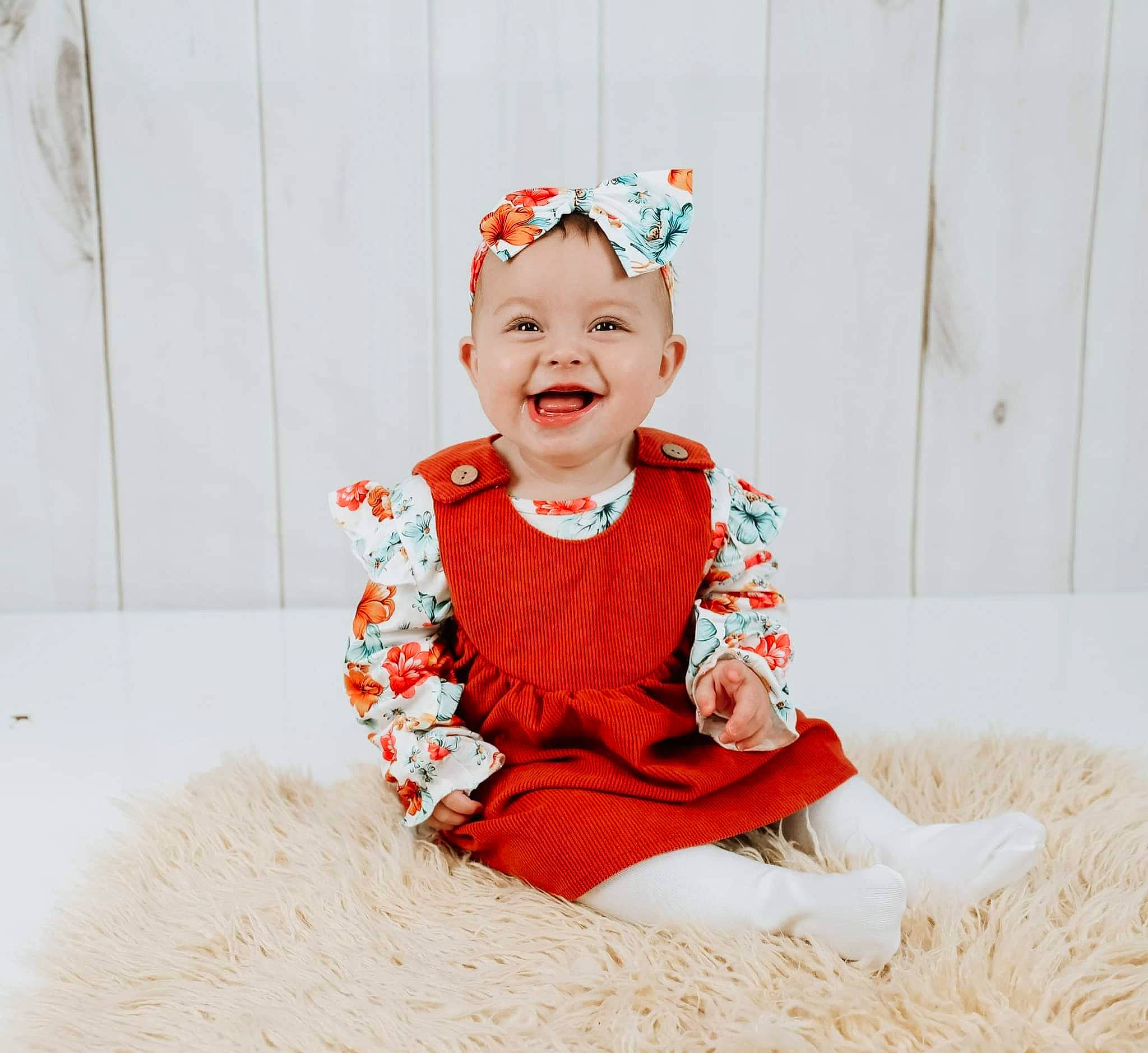 Maddie is registered to the contest to win money with this photo: baby, baby_toddler_clothing, child, costume, costume_hat, dress, event, fashion_accessory, fun, happy, head, headband, headpiece, headwear, jewellery, joy, pattern, peach, person, sitting