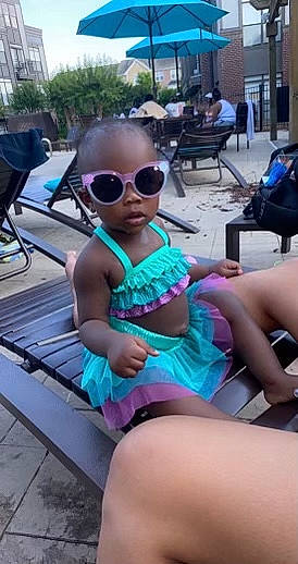 Hannah C. Wilks is registered to the contest to win money with this photo: baby_toddler_clothing, electric_blue, eyewear, foot, fun, glasses, goggles, happy, hat, human_leg, knee, lap, leisure, outdoor_furniture, person, personal_protective_equipment, sitting, sunglasses, thigh, toddler