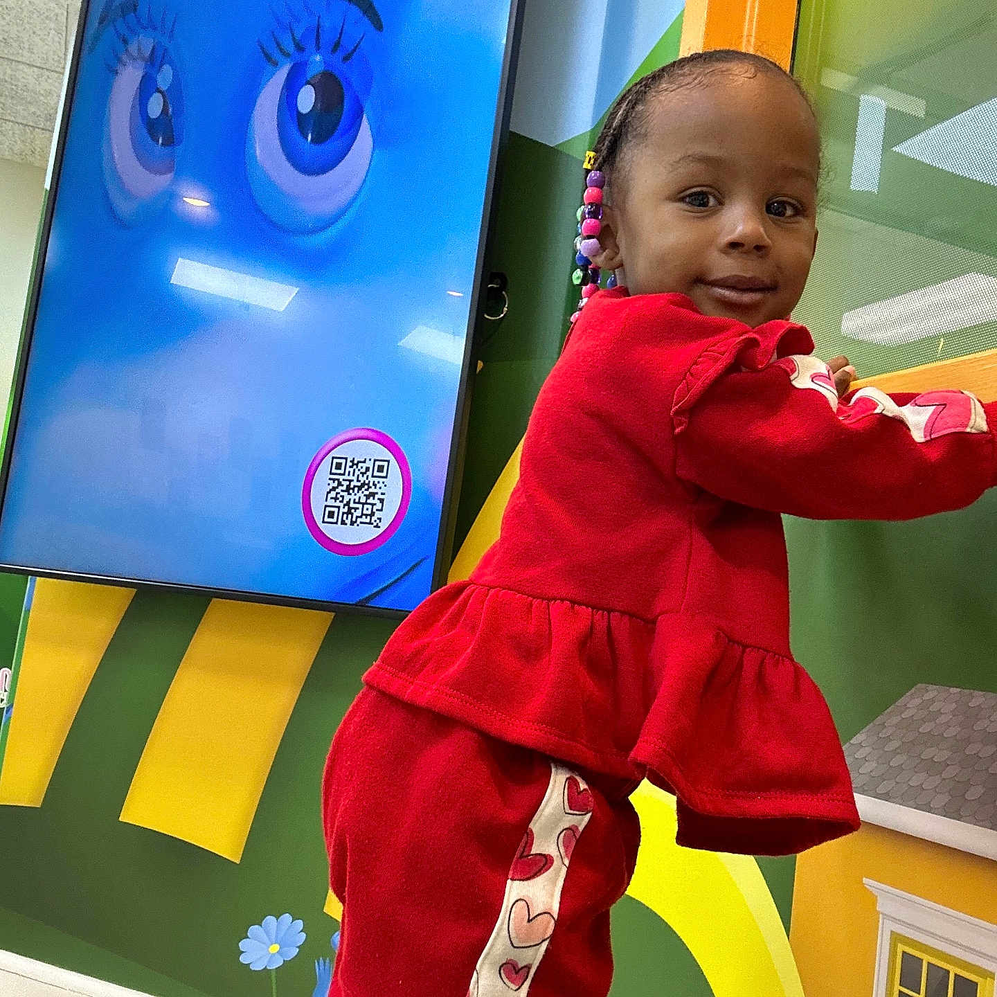 Tiana is registered to the contest to win money with this photo: baby, clothing, coat, face, footwear, happy, head, indoors, interiordesign, jacket, outdoors, pants, person, photography, playarea, portrait, qrcode, shoe, sleeve, standing