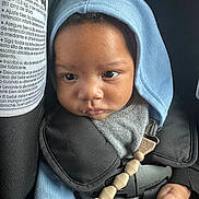 Jaidyn -Andre joined the competition — help win amazing prizes! baby, child, face, hood, car_seat, seatbelt, clothing, pacifier_clip, hand, infant, straps, closeup, indoors, expression, cute, young_child, skin, eyes, headwear, safety