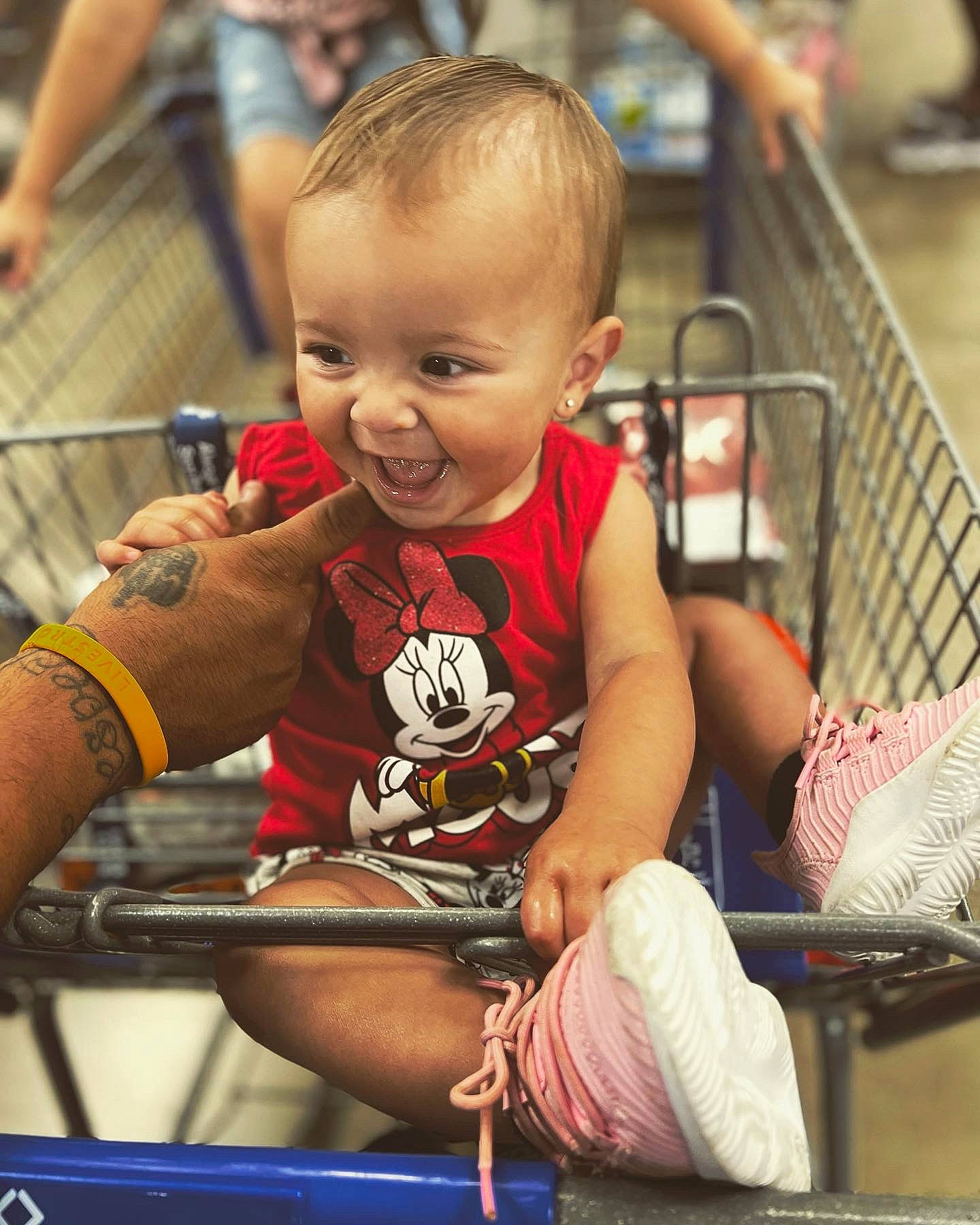 Leila is registered to the contest to win money with this photo: baby, chair, child, elbow, fun, happy, human_leg, leisure, pattern, person, play, product, recreation, shorts, sitting, skin, smile, t_shirt, thigh, toddler