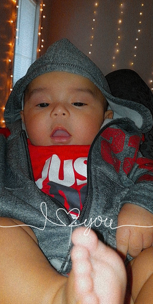 Jesus is registered to the contest to win money with this photo: baby, baby_toddler_clothing, beauty, cap, cheek, chin, comfort, cool, finger, happy, headgear, headwear, lip, mouth, muscle, nail, nose, organ, person, skin